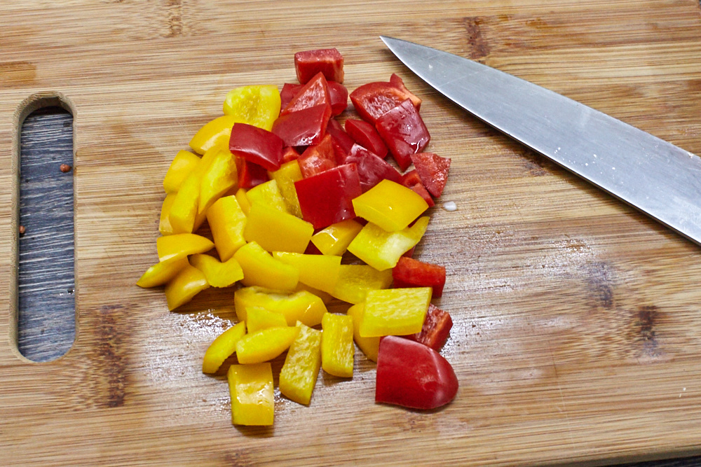 Cut all peppers for chicken with vegetables in sour-sweet sauce