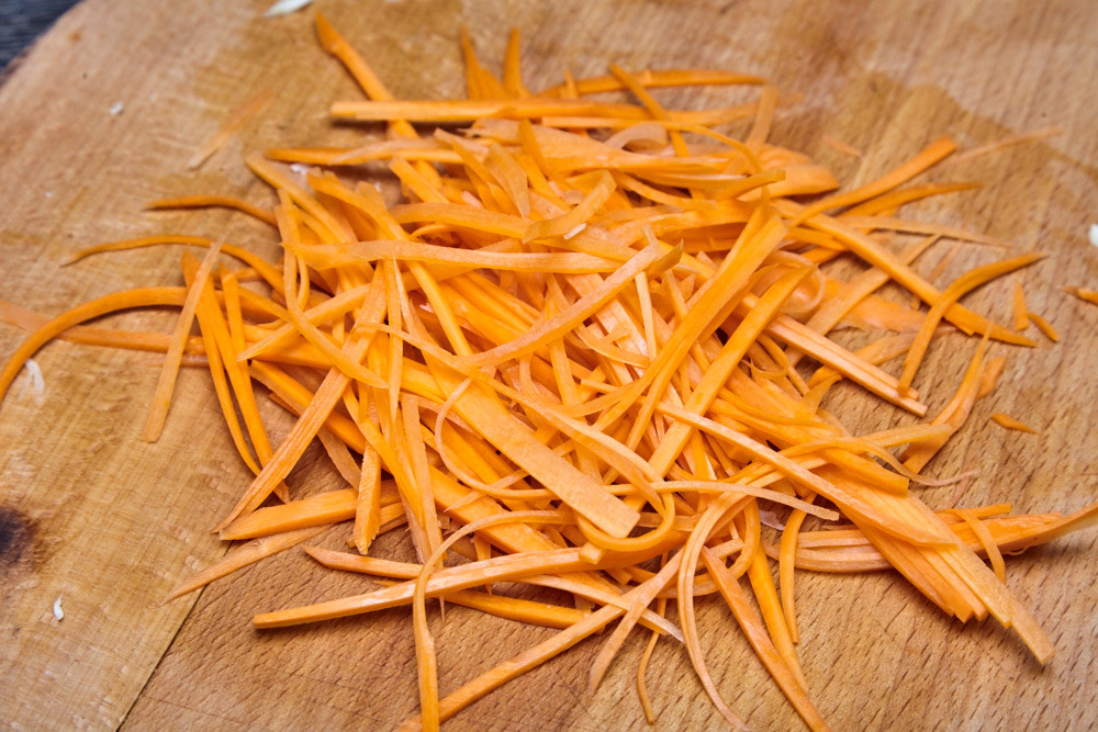 Cut the carrot into thin slices for cabbage salad coleslaw from jamie oliver