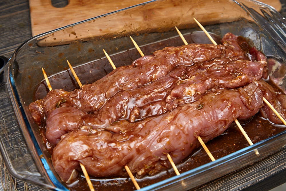 Poke the meat across with sticks for texas style pork loin