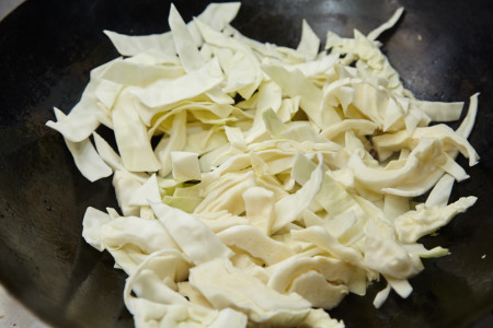 Add cabbage and constantly stirring cook for chinese fried cabbage
