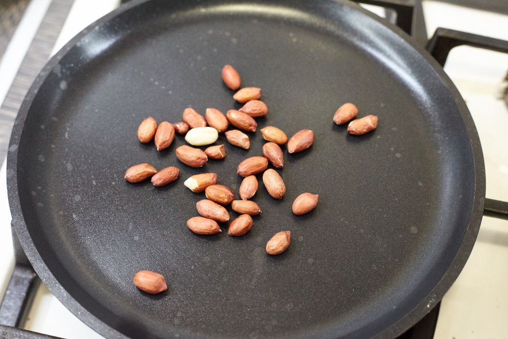 A handful of peanuts fry for a couple of minutes for zesty thai salad with beef