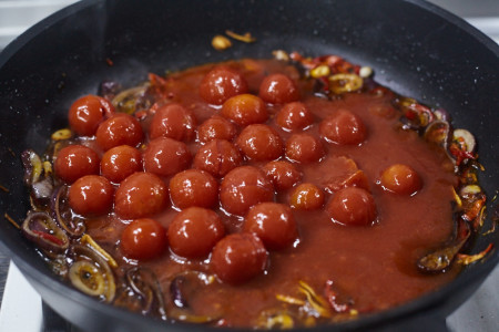 Додайте 400 гр рубаних томатів у власному соку. Якщо використовуєте цілісні – можете їх посікти самостійно ножем чи лопаткою вже у сковороді.
