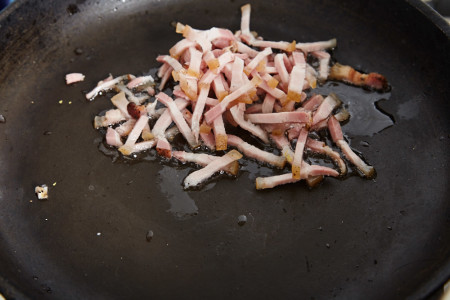 Fry sliced bacon until golden for jamie oliver's potato salad with a bacon