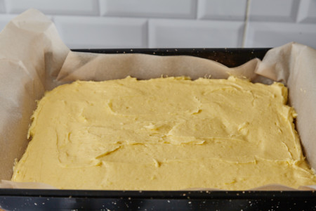 Put the dough to the prepared form for lemon pie with frosting