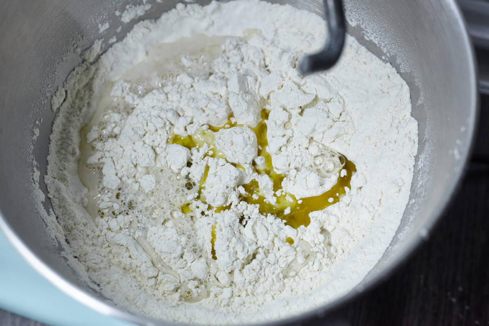 Add water and olive oil to the flour for italian breadsticks grissini
