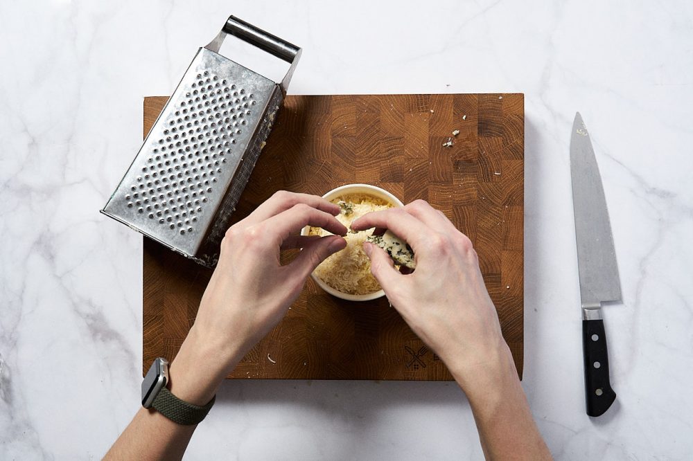Grate the parmesan and cheddar on a fine grater. Grate the blue cheese with your hands. Set aside