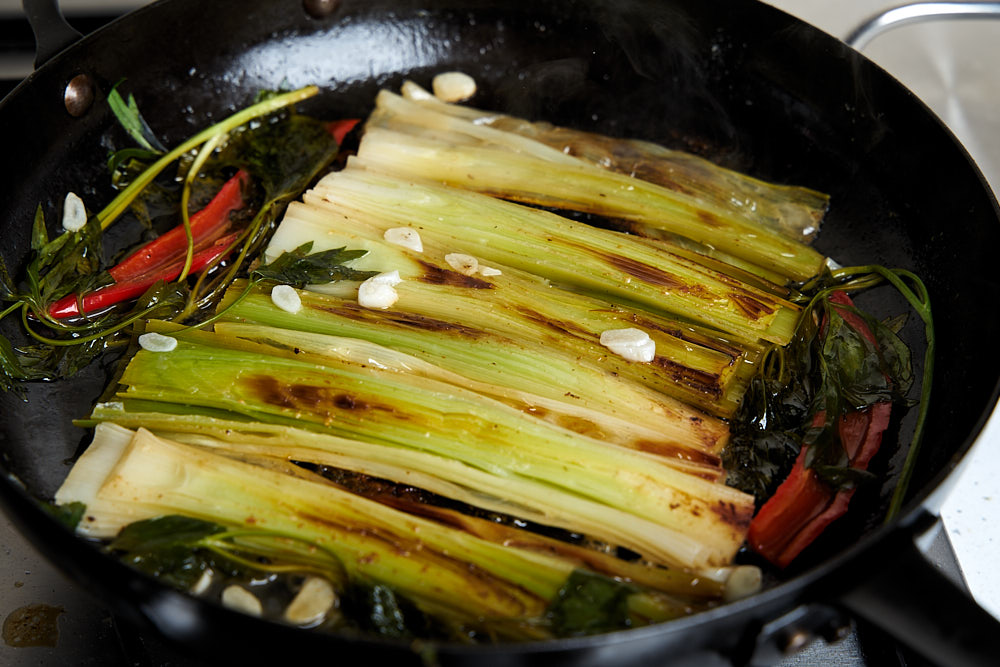 Leeks stewed in wine at the end of the cooking process