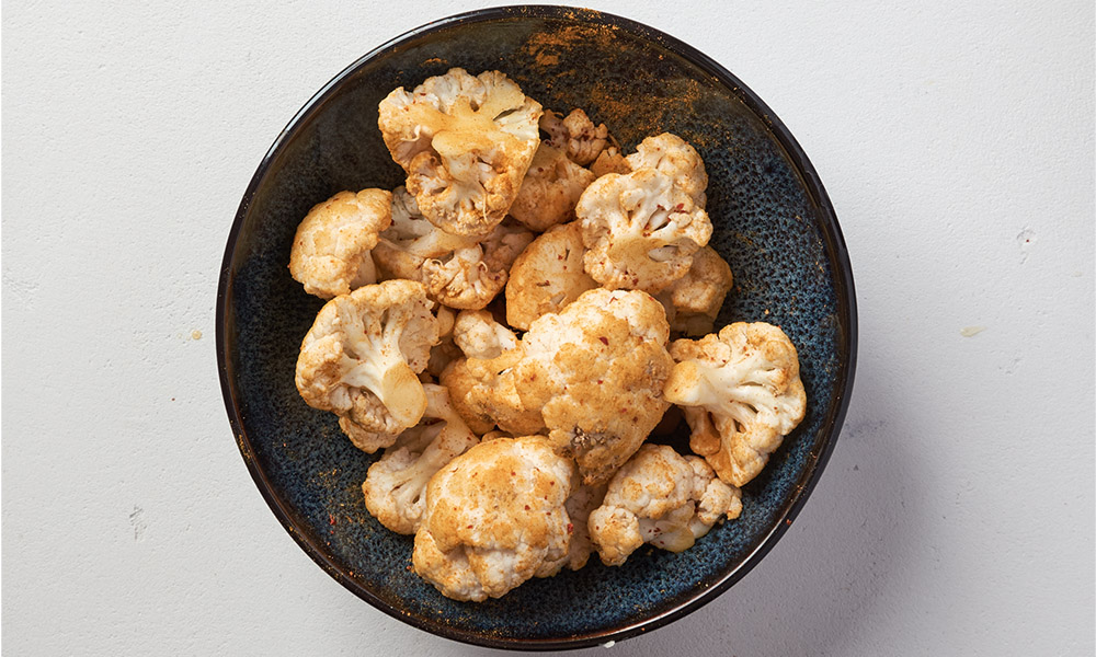 Coat the cauliflower florets with spices for cauliflower pilaf