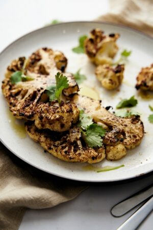 Baked Cauliflower Steak. Cauliflower Steak baked in the oven with lemon juice and zest, Worcester sauce, garlic, onion and smoked paprika. Recipe with step by step Directions