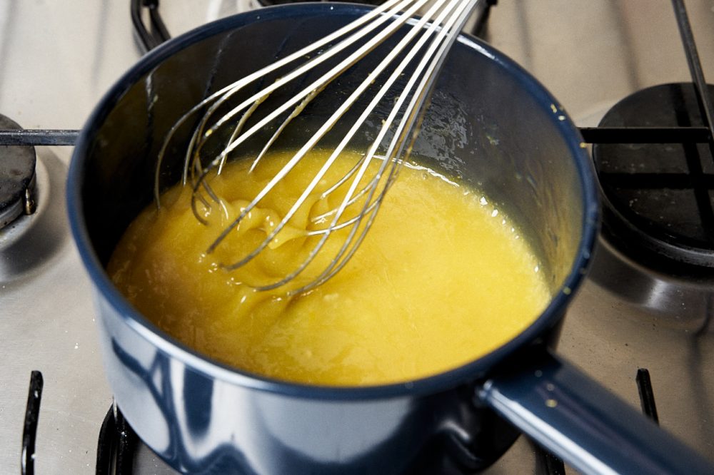 Cook the lemon curd until it thickens