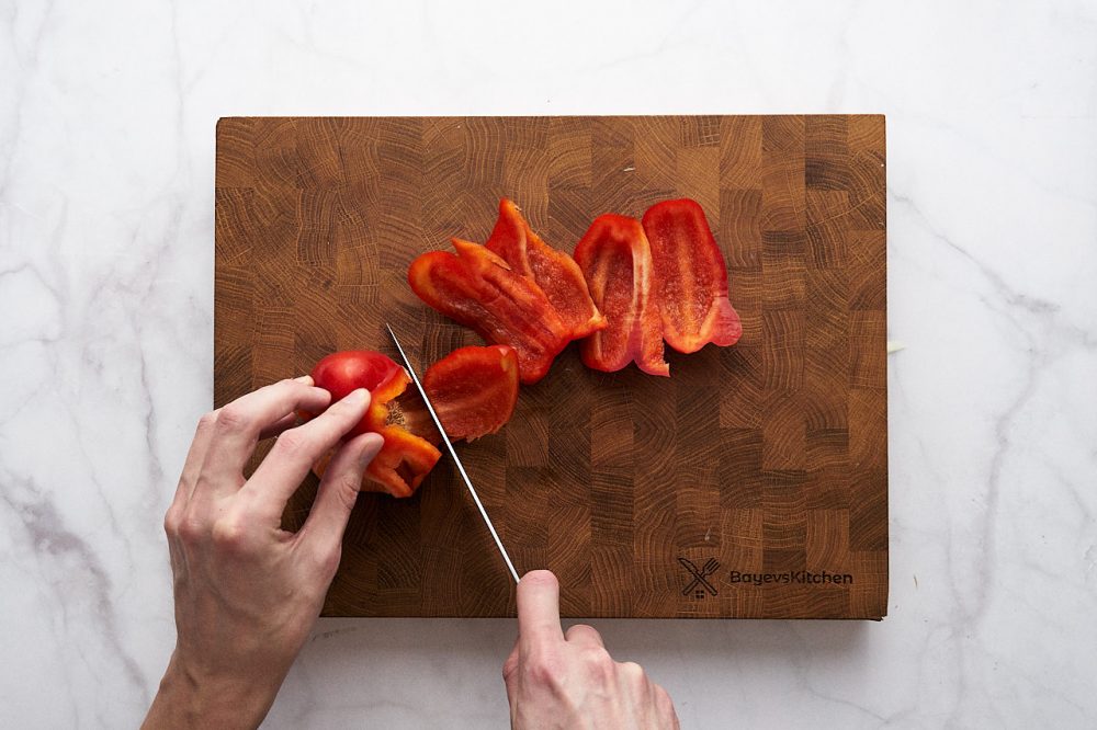 Slice red bell peppers into long thin strips
