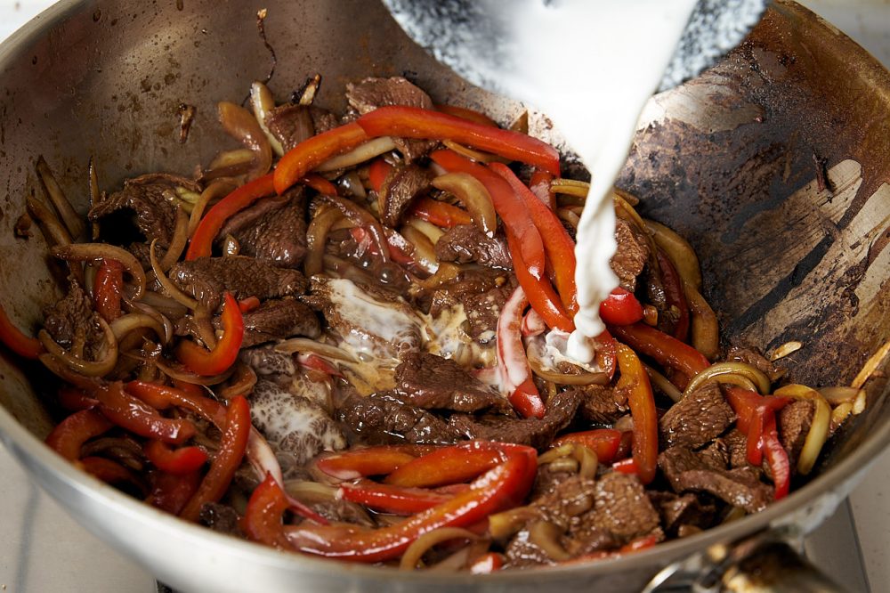 Return the beef to the pan, stir and pour in the sauce