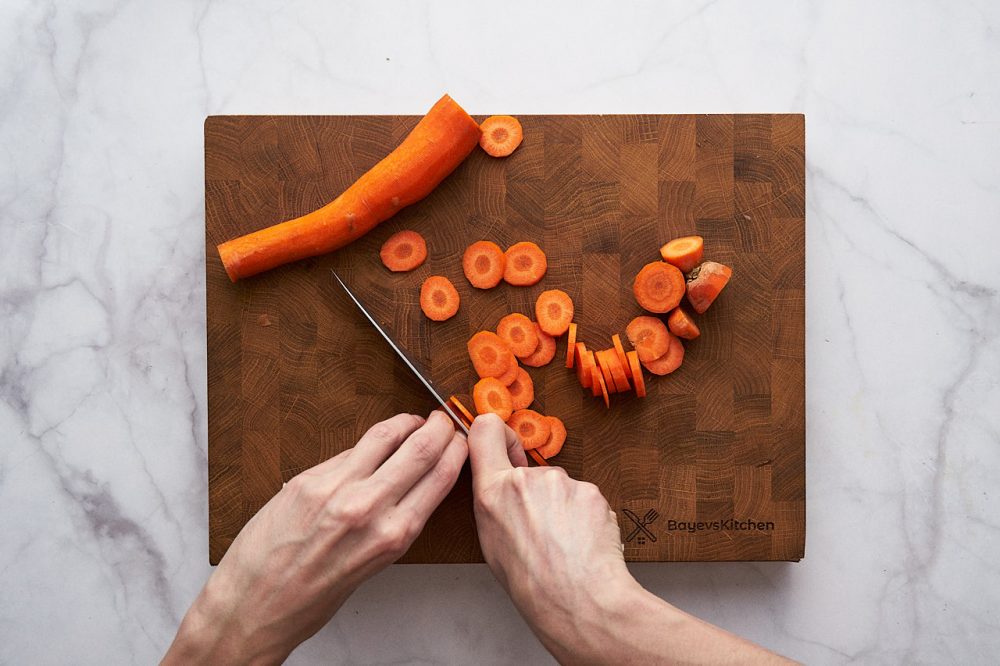 Thinly slice the carrots 