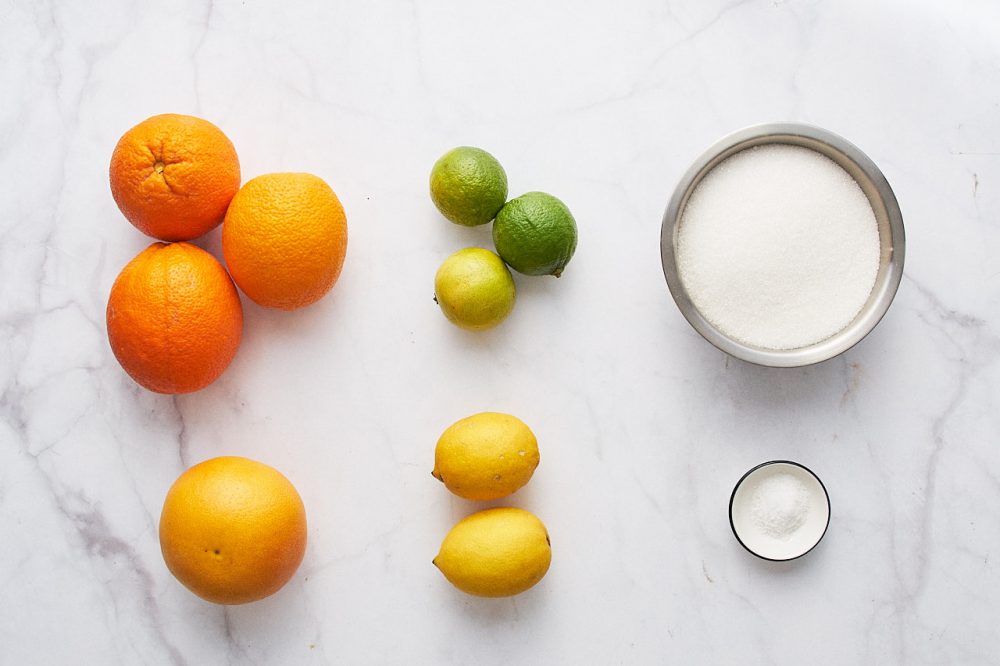 Ingredients for making candied fruit: oranges, limes, lemons, grapefruit, sugar, salt.