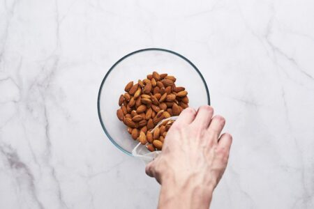 Pour the almonds into a deep bowl or bowl