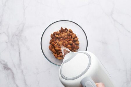 Pour boiling water over the almonds