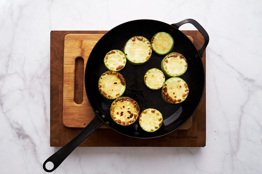 Fry zucchini circles on both sides until golden brown