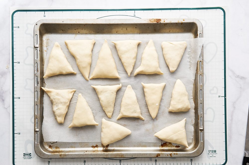 Place triangles of dough on a baking tray