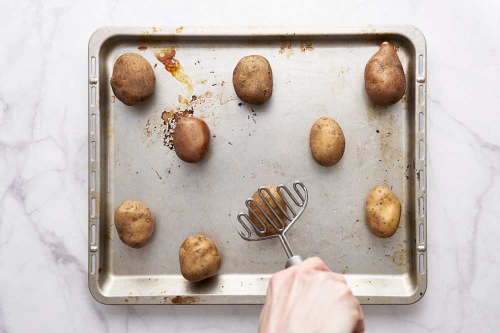 Crush the potatoes with a potato masher