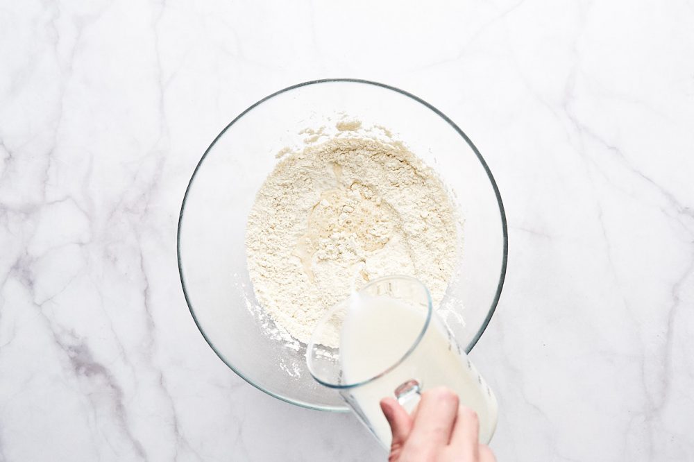 Pour warm milk into the flour