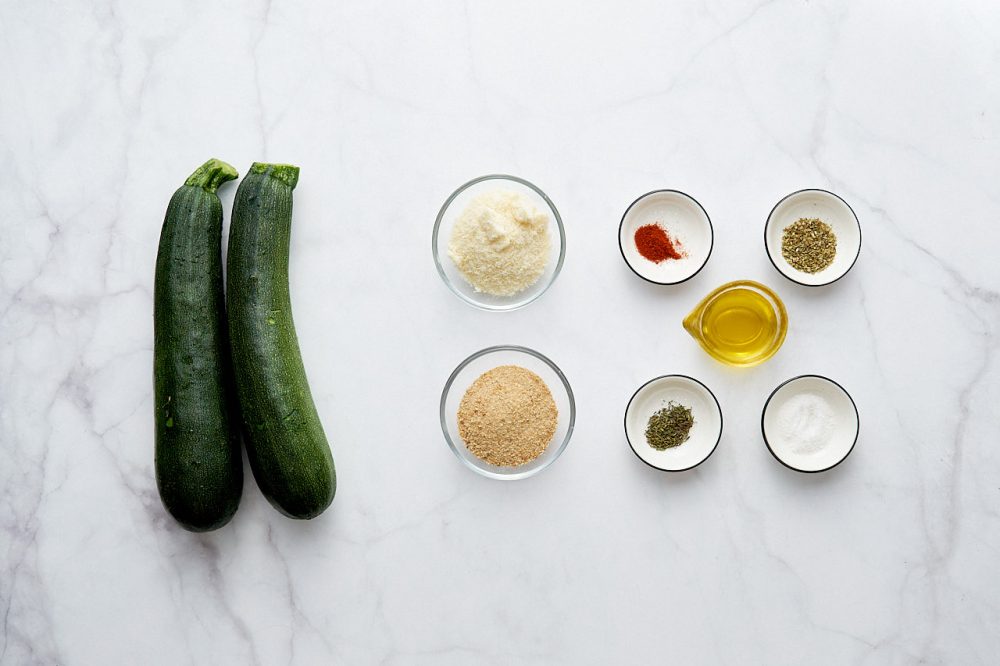 Ingredients for baked zucchini in parmesan breading: zucchini, parmesan, sweet paprika, oregano, breadcrumbs, thyme, salt, olive oil, black pepper.