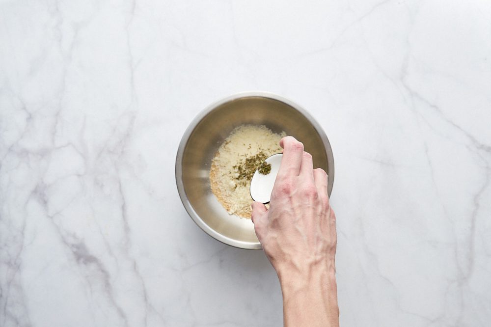 To prepare the breading, add oregano to a bowl