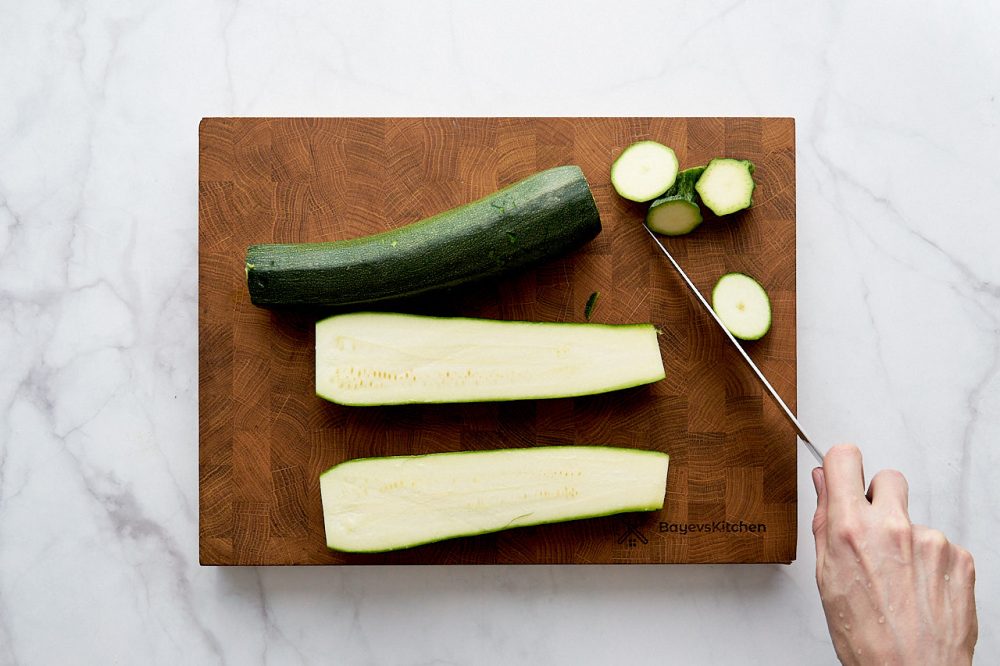Cut in half zucchini for baked zucchini in parmesan breading for a quick bake