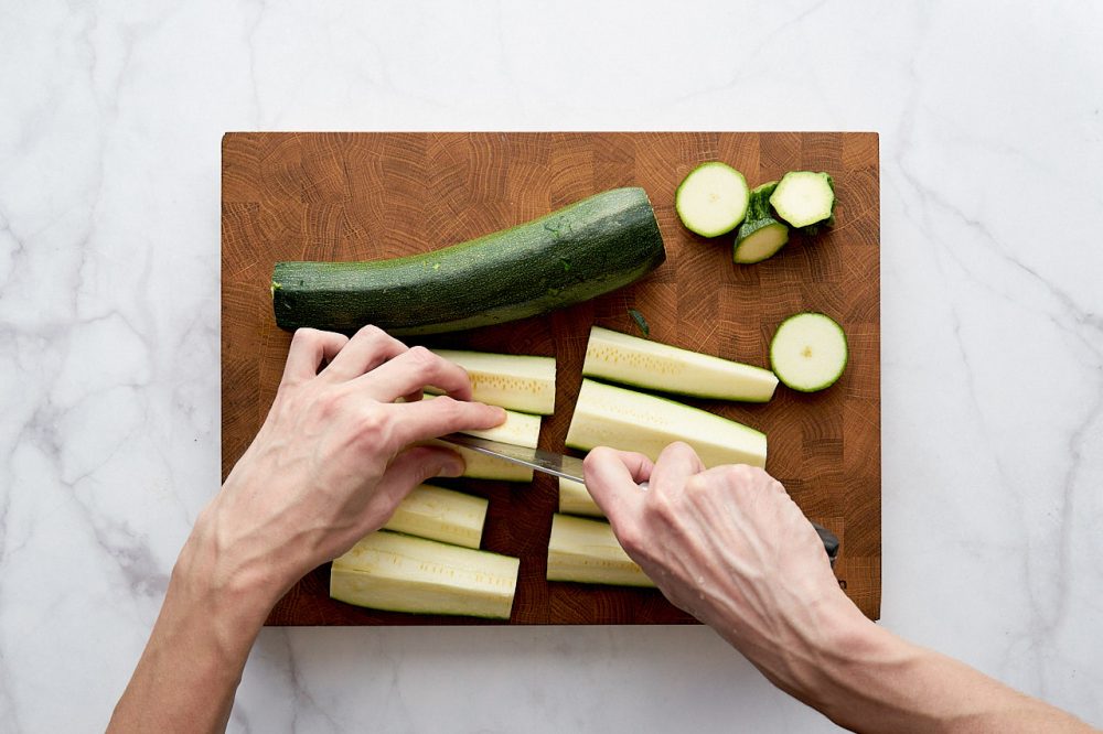 Cut large quarters of zucchini in half more