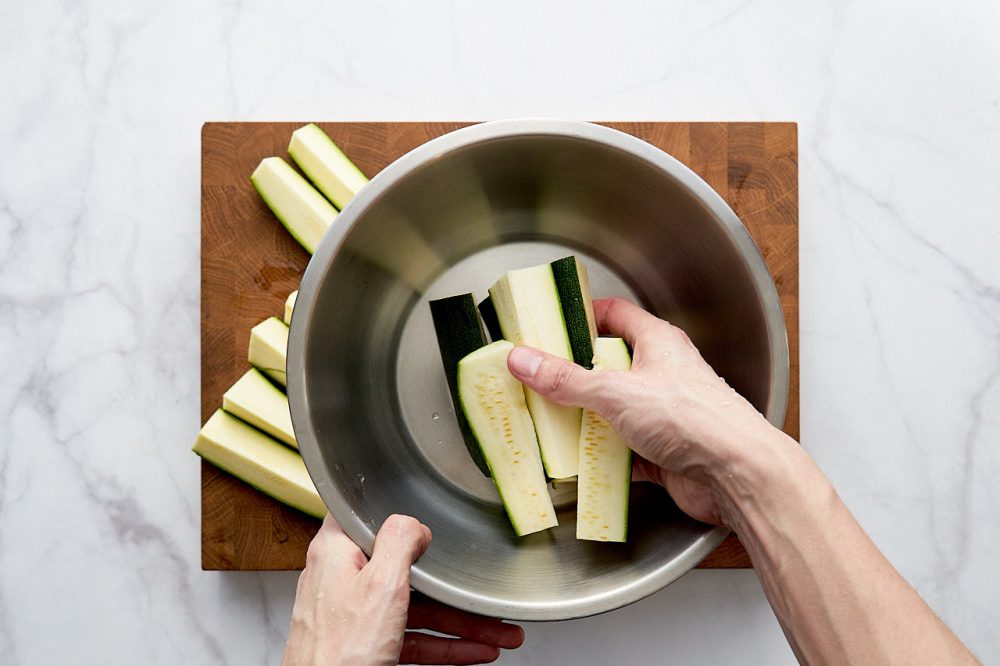 Transfer the zucchini slices to a bowl