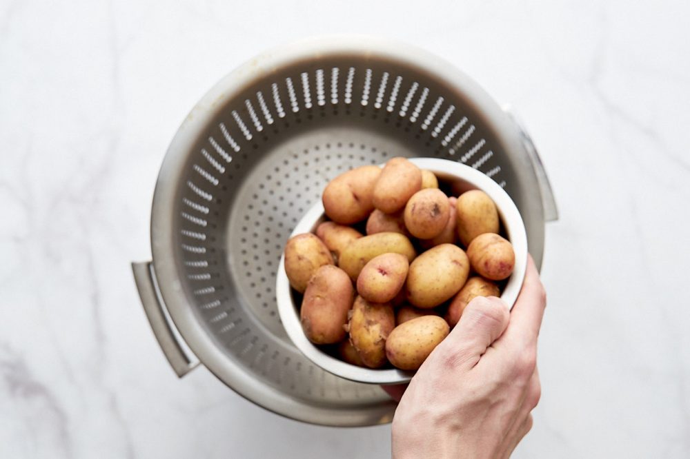 Transfer the new potatoes to the steamer for cooking