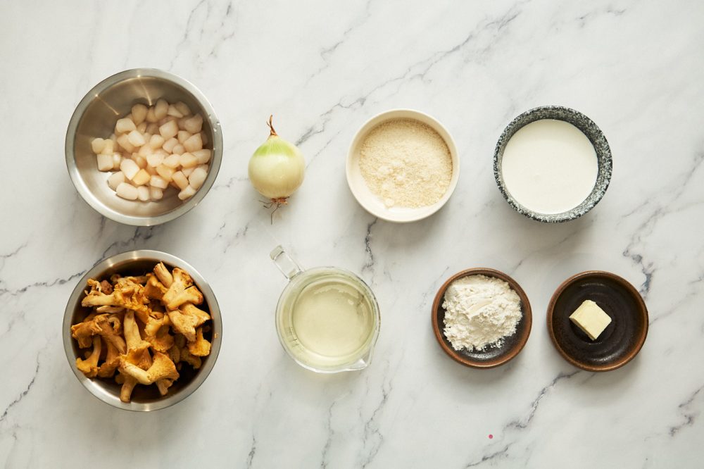 Ingredients needed to cook scallops with chanterelles in cream sauce: small scallops, onion, chanterelles, white wine, flour, cream, Parmesan cheese, butter, salt, pepper.