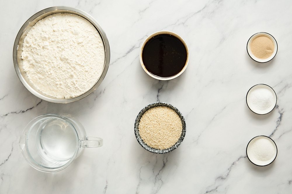 Ingredients needed to make simit: flour, salt, sugar, warm water, yeast, pectrose, white sesame