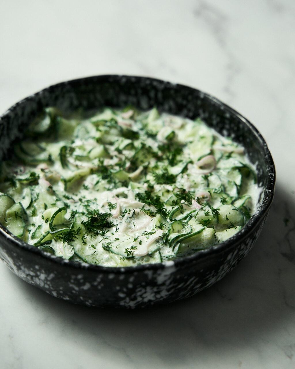 Cucumber salad with sour cream, onion and dill