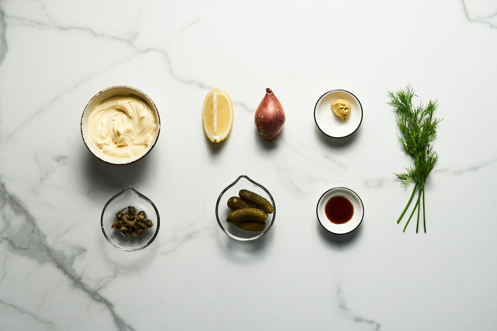 Ingredients for classic tartar sauce: mayonnaise, capers, pickles, dill, shallot, Worcester sauce, Dijon mustard, black pepper, lemon 