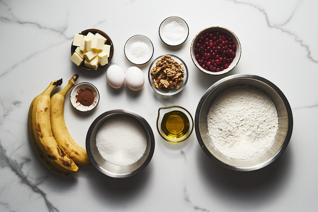 Ingredients needed to make Banana Bread with Cranberries and Walnuts: butter, sugar, eggs, bananas, nuts, fresh cranberries, cinnamon, olive oil, flour, salt, baking powder