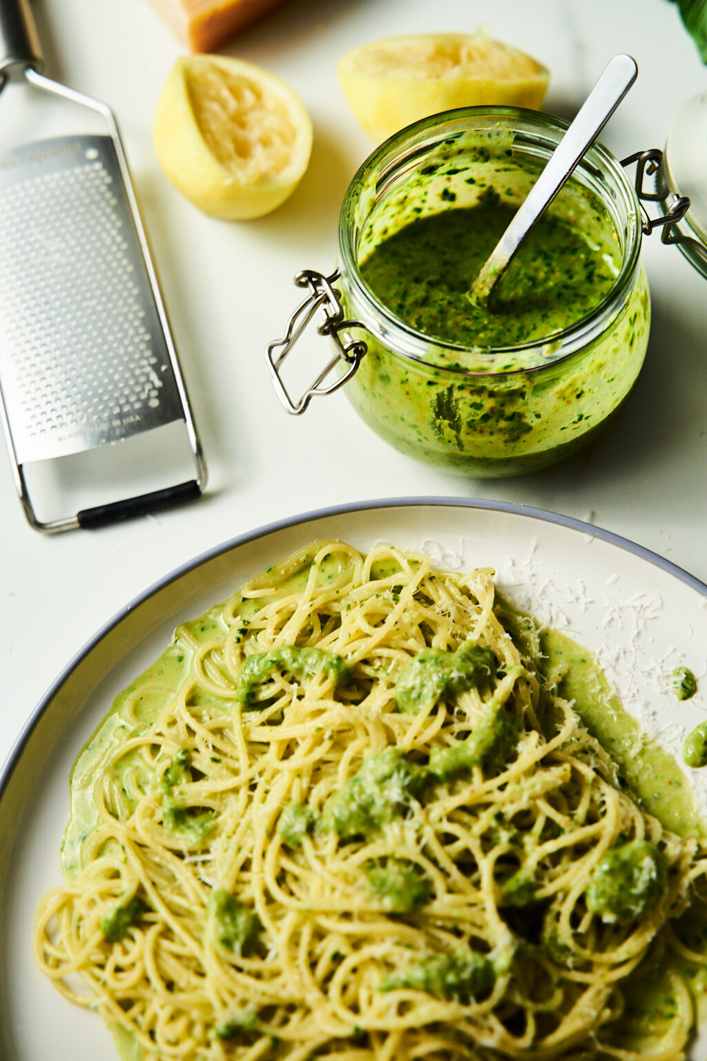 Lemon pesto in a jar and with pasta on a platter