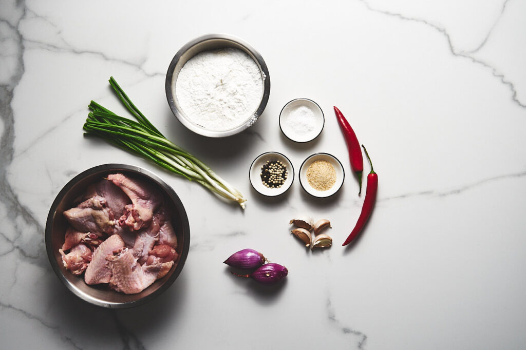 Ingredients needed to make Salt and Pepper Chicken Wings: chicken wings, cornstarch, flour, garlic, green onions, shallots, chili, white pepper, black pepper, granulated garlic, salt, frying oil