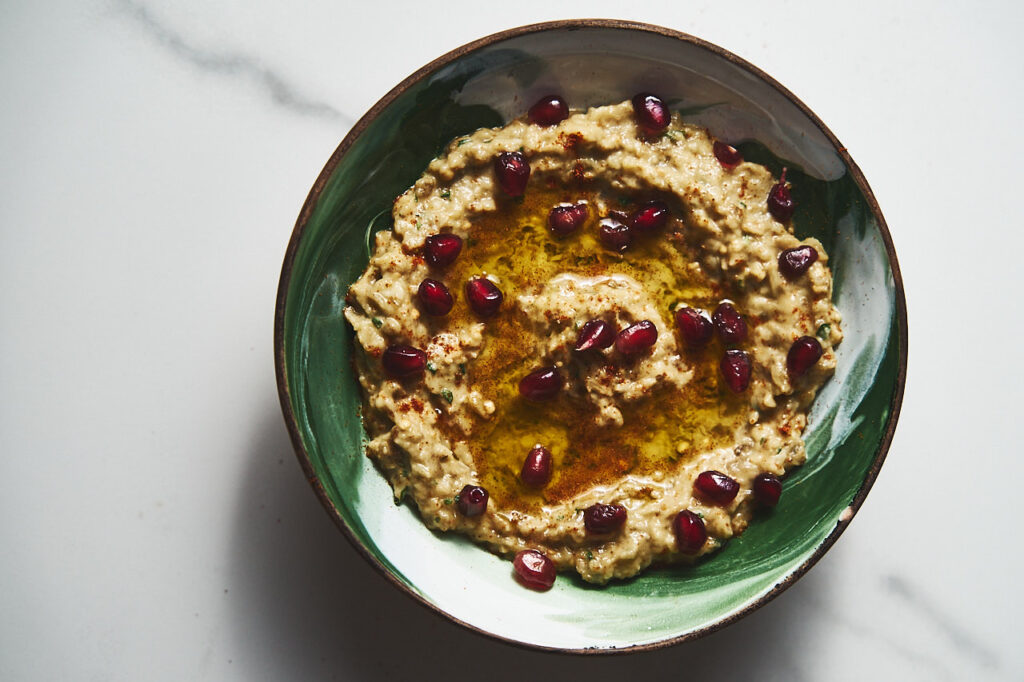 Baba Ganoush with olive oil, pomegranate grains on a platter
