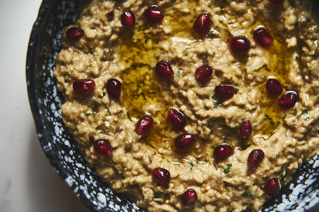 Baba Ganush on a platter with pomegranate grains.