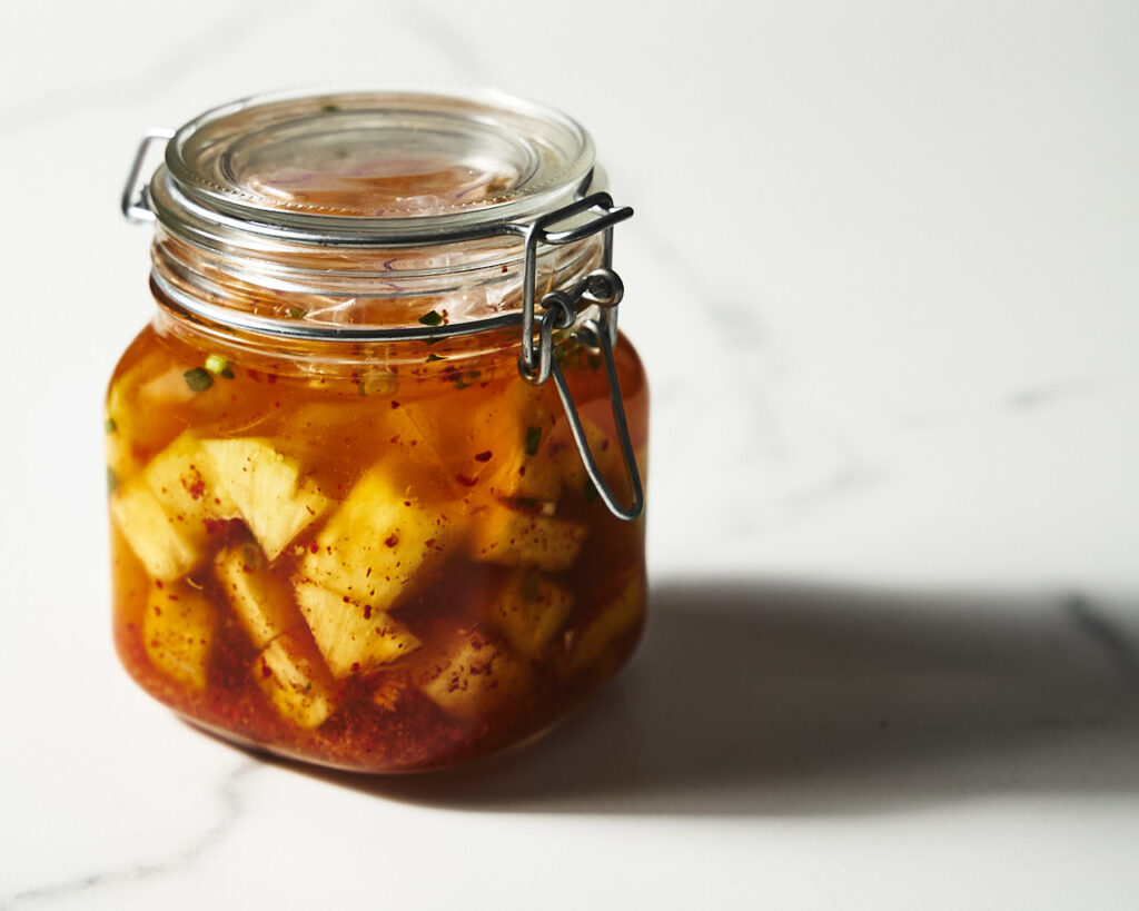 Fermented pineapple kimchi in a glass fermentation jar