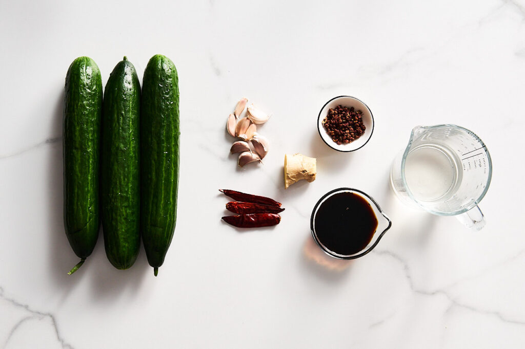 Ingredients needed to prepare Not beaten cucumbers or Chinese style pickles with soy sauce, garlic and chili: cucumbers, garlic, chili peppers, ginger, soy sauce, sugar, sichuan pepper, salt, vinegar, water, sesame oil, cilantro or green onion, sesame seeds